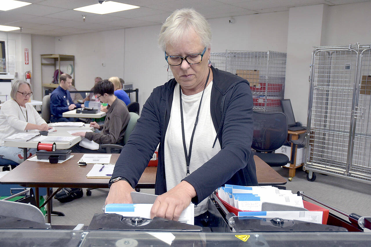 Photo by Keith Thorpe/Olympic Peninsula News Group
Clallam County election worker Janet Parris of Port Angeles sorts through incoming primary ballots at the Clallam County Courthouse on Aug. 6.