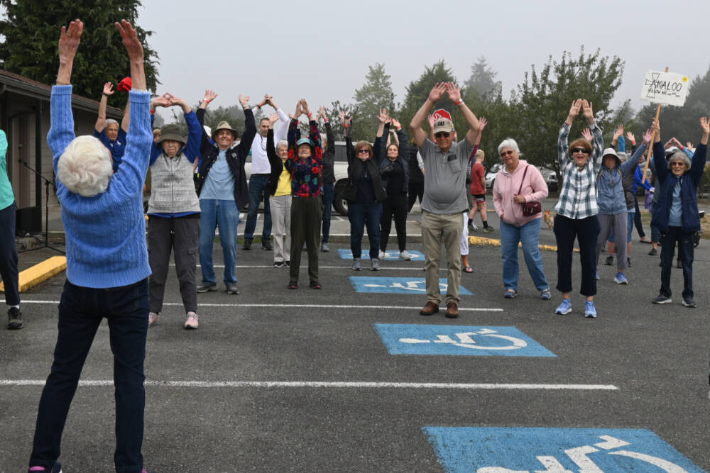 Sequim Gazette photo by Michael Dashiell / Barb Paschall (at left in foreground) leads stretches before the Dungeness Valley Health & Wellness Clinic’s 17th Fun Walk and Health Fair, held Aug. 10 at Trinity United Methodist Church. All proceeds support the Dungeness Valley Health & Wellness Clinic, an organization that offers basic urgent care and chronic medical care for the uninsured and under-insured in the community. The clinic operates two Basic Urgent Care clinics per week and three to four Chronic Health Care clinics per month, at 777 N. Fifth Ave.