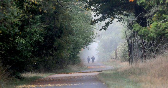 Walkers make their way along a foggy portion of the Olympic Discovery Trail near William R. Fairchild International Airport in Port Angeles. Areas of fog covered many portions of the North Olympic Peninsula on Thursday with wetter weather forecast for weekend. (Keith Thorpe/Peninsula Daily News)