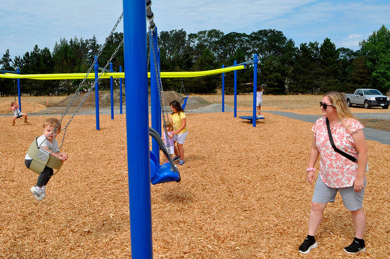 Sequim Gazette photos by Matthew Nash
Mallory Dobbs pushes her son one-year-old Caleb at Olympic View Church’s soft opening for The Gathering Ground playground’s first phase on Aug. 16.