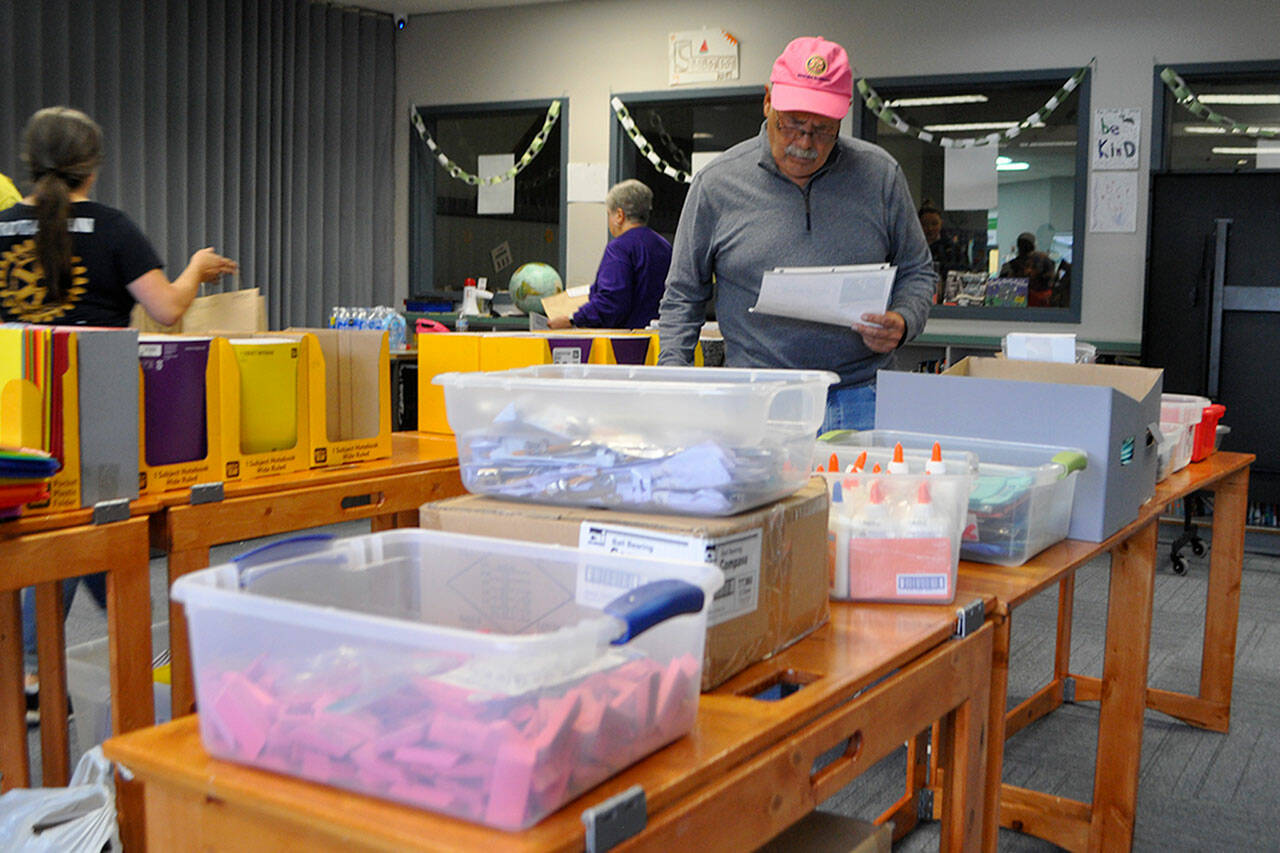 Tom Hall with the Sequim Sunrise Rotary was one of many volunteers helping fill orders for school supplies for families at the Back to School Fair on Aug. 24 in the Sequim Boys & Girls Club.