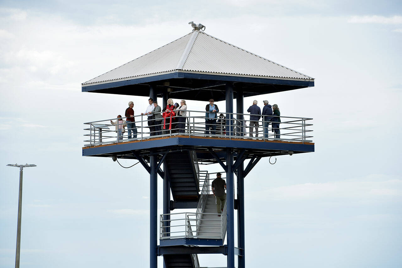 Photo by Keith Thorpe/Olympic Peninsula News Group / Visitors and dignitaries ascend the steps at the observation tower at Port Angeles City Pier on Aug. 21 after a ceremony to officially reopen the structure to the public. The tower was closed in November 2023 due to safety issues and structural concerns, prompting numerous repairs. Funding for the work, totaling more than $650,000, came from city lodging tax.