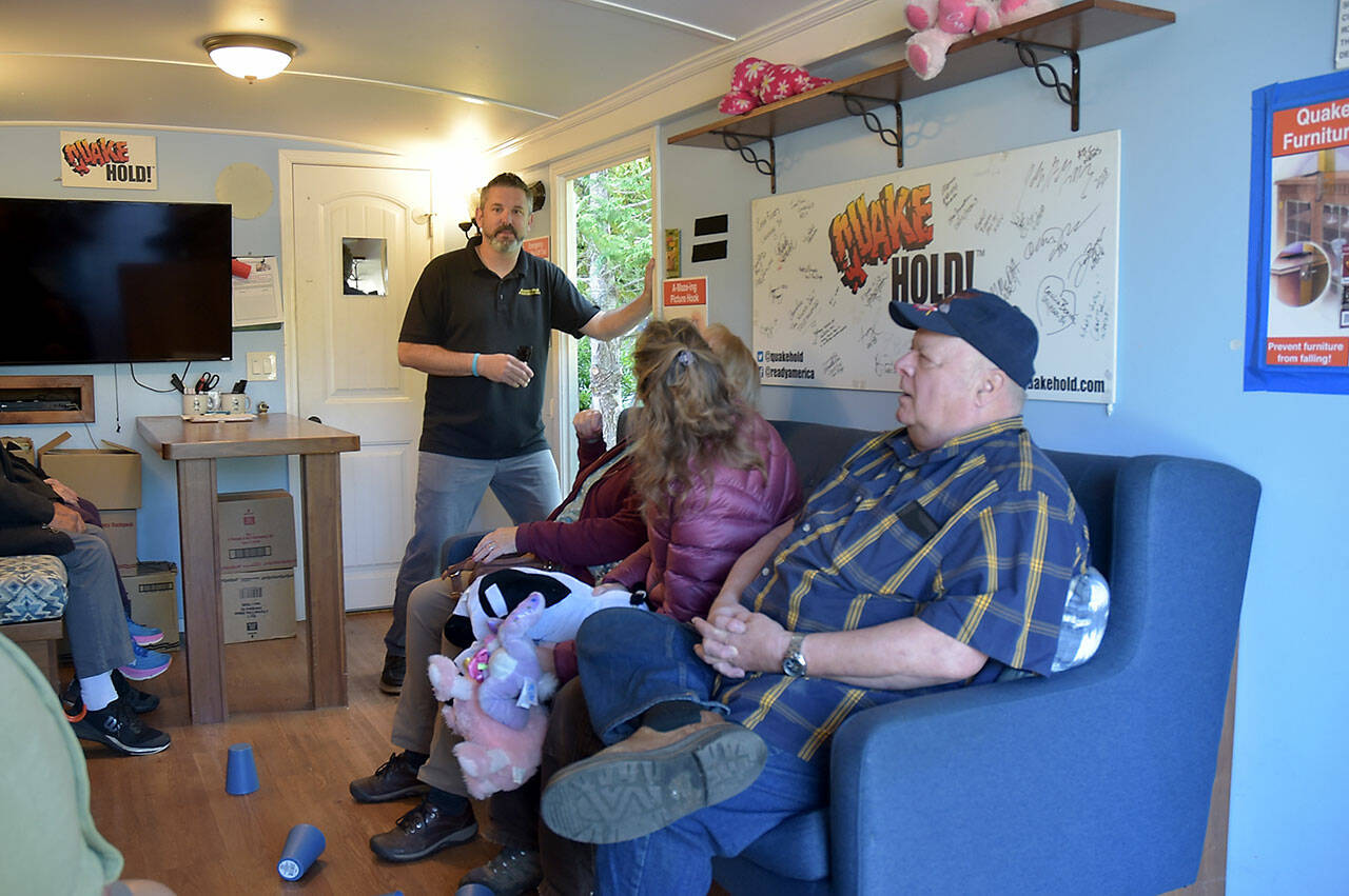 Photo by Keith Thorpe/Olympic Peninsula News Group
Tom Waertz of Ready America, left, runs an earthquake simulation in a shake trailer on Aug. 28 as participants, from left, Sequim EMT Lisa Law, CERT member Anne Koepp of Joyce and Jim Buck of the Joyce Emergency Planning and Preparation Group recover after being jolted by a 6.8-magnitude quake.