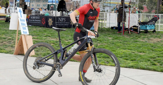 Calvin Colander of Bellingham-based Team Improbability Drive heads for the handoff after finishing the mountain bike leg of the 2023 Big Hurt in Port Angeles. (Keith Thorpe/Peninsula Daily News)