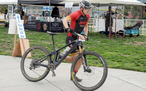 Calvin Colander of Bellingham-based Team Improbability Drive heads for the handoff after finishing the mountain bike leg of the 2023 Big Hurt in Port Angeles. (Keith Thorpe/Peninsula Daily News)