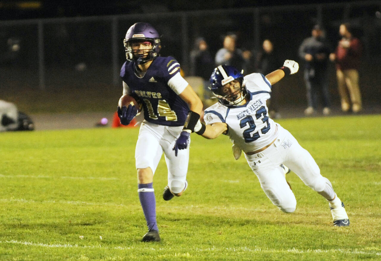 Sequim Gazette file photos by Michael Dashiell
Sequim’s Zeke Schmadeke, left, races away from North Mason defender Caden Atencio in the Wolves’ 36-0 Homecoming victory in 2023. Schmadeke looks to take over at quarterback in this, his senior season.