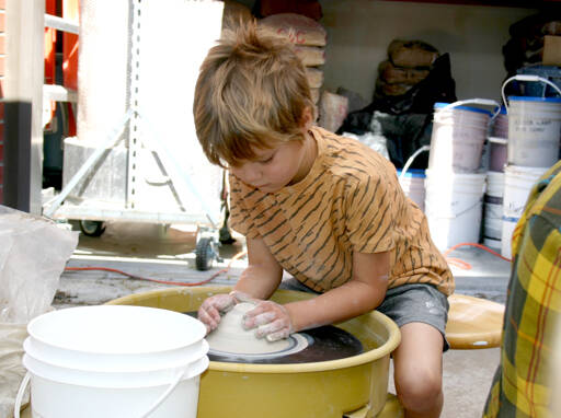 Photo by Paula Hunt/Olympic Peninsula News Group
Eliott Carey, 5, shapes a mound of clay on a potter’s wheel on the patio of Peninsula College’s ceramics studio at its second Fall Spectacular in 2023. This year’s event is scheduled for Saturday, Sept. 7.