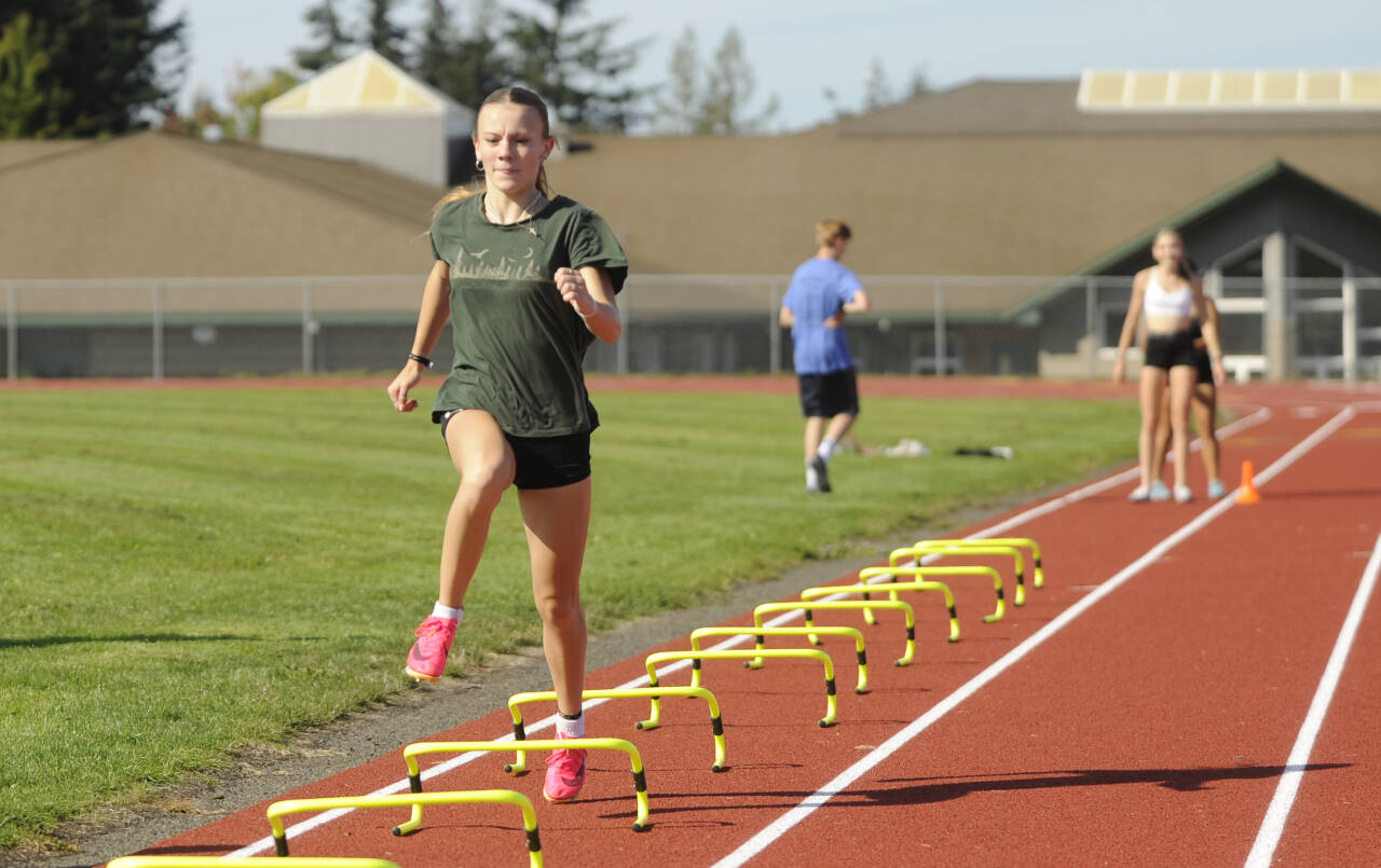 Sequim Gazette photo by Michael Dashiell / Sequim’s Bridgett (“Birdie”) Pyeatt gets a high-leg workout at the SHS track last week as she and cross country teammates prep for the 2024 season.