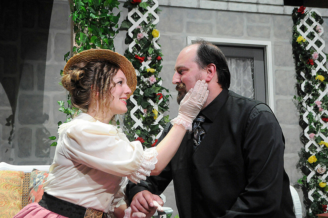 Sequim Gazette photos by Matthew Nash
Gwendolen (Merrin Packer) and Jack/Ernest (Sean Stone) embrace during a scene of “The Importance of Being Earnest” when he proposes to her.