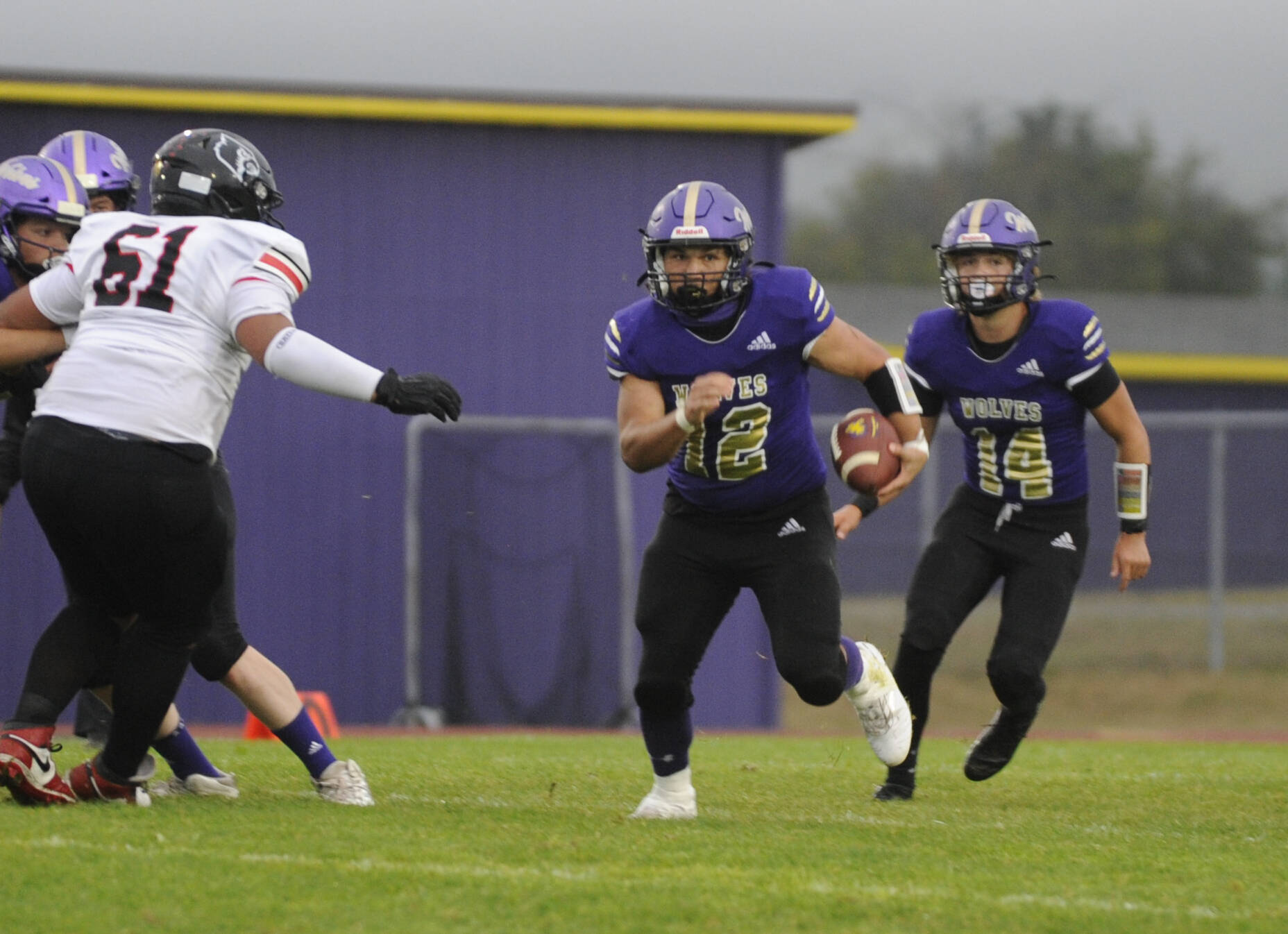 Sequim Gazette photo by Michael Dashiell
Sequim’s Liam Wiker, left, finds some running room in the Wolves’ 36-14 loss to Franklin Pierce on Sept. 13, with teammate Zeke Schmadeke looking on.The pair combined for 126 rushing yards in the loss.