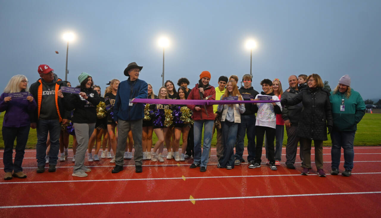 Sequim Gazette photo by Michael Dashiell / Sequim High sophomore Clare Turella does the honors, cutting a ceremonial ribbon to celebrate the Sequim School District’s newly-refurbished track on Sept. 13. Turella won a state 2A high jump title as a freshman in 2023.