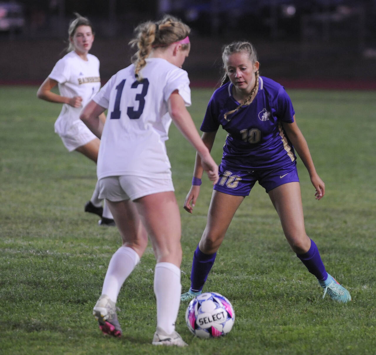 Sequim Gazette photo by Michael Dashiell / Sequim freshman forward Kaiya Robinson, right, guards Bainbridge’s Rosey Romney in the first half of a Sept. 19 Olympic League game in Sequim. Bainbridge scored two second half goals to prevail, 2-0.