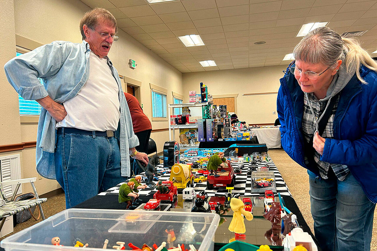 Sequim Gazette photo by Matthew Nash/ Nuna Bear of Sequim talks with toy vendor Dick Cays at the second Olympic Peninsula Toy and Collectibles Show on Sept. 14. She was looking for a Matchbox toy similar to her grandpa’s 1950s Ford truck. Event organizer Corey Edwards said the event was successful and they will bring back another show, possibly in the spring at the Guy Cole Event Center in Carrie Blake Community Park. To learn more, visit <a href="https://facebook.com/groups/peninsulatoyshow" target="_blank">facebook.com/groups/peninsulatoyshow</a>.