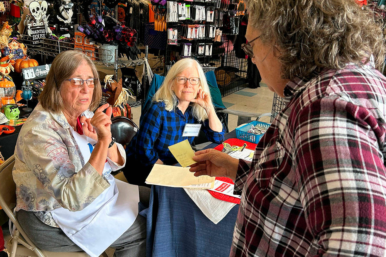 Sequim Gazette photo by Matthew Nash/ Volunteers Barbara VanderWerf and Maren Halverson with the Clallam County League of Women Voters speak with a customer at Sequim Goodwill about ballot information on Sept. 17 during an information session held in conjunction with the stores in Sequim and Port Angeles on National Voter Registration Day.