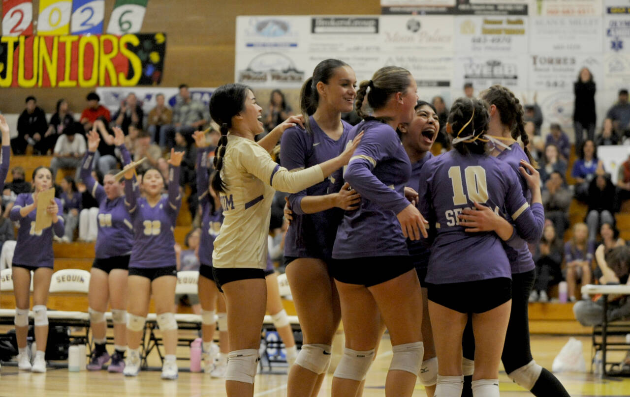 Sequim Gazette photo by Michael Dashiell / Sequim players celebrate after earning a point in the 19th set of their home match against Bainbridge on Sept. 19.