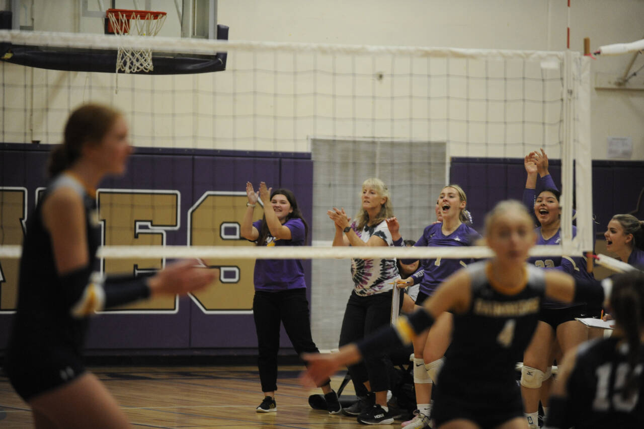 Sequim Gazette photo by Michael Dashiell / Sequim coaches celebrate a key point in the third set of a league game against Bainbridge on Sept. 19.