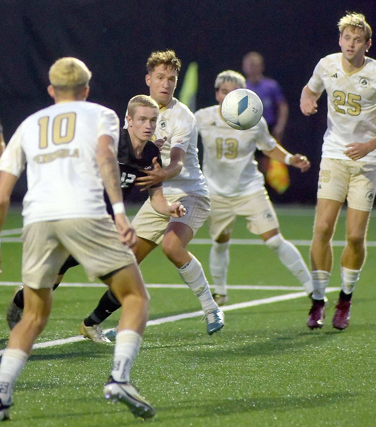 Photo by Keith Thorpe/Olympic Peninsula News Group / Everett’s Lunden Fenster, second from left, eyes a loose ball surrounded by Peninsula’s (from left) Nil Grau, Konrad Mueller, Ezrrah Ochoa, and Sid Gunton-Day on Sept. 18 in Port Angeles.