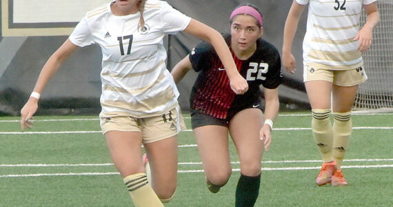 KEITH THORPE/PENINSULA DAILY NEWS
Peninsula's Emma Crystal, left, drives down the pitch pursued by Everett's Cassandra Sotelo as Crystal's teammate, Gemma Rowland, keeps watch on Wednesday at Wally Sigmar Field.