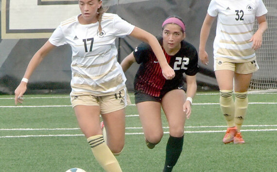 KEITH THORPE/PENINSULA DAILY NEWS
Peninsula's Emma Crystal, left, drives down the pitch pursued by Everett's Cassandra Sotelo as Crystal's teammate, Gemma Rowland, keeps watch on Wednesday at Wally Sigmar Field.