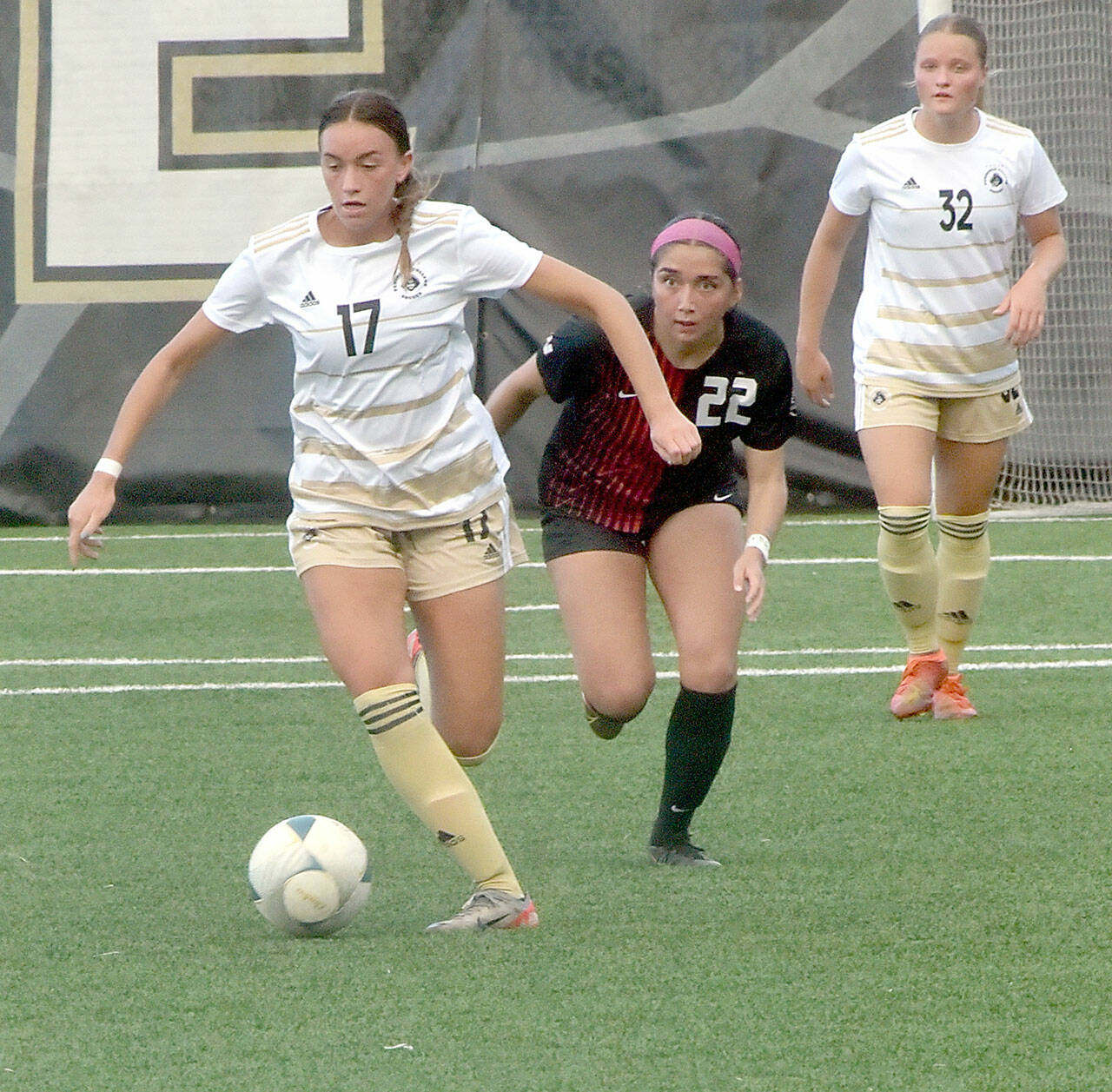 Photo by Keith Thorpe/Olympic Peninsula News Group / Peninsula’s Emma Crystal, left, drives down the pitch pursued by Everett’s Cassandra Sotelo as Crystal’s teammate, Gemma Rowland, keeps watch on Sept. 18 at Wally Sigmar Field.