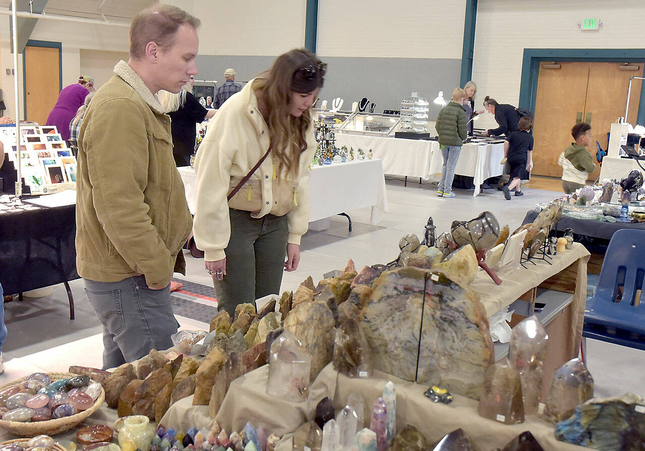 Photo by Keith Thorpe/Olympic Peninsula News Group
Jason Eason, left, and Amanda Krott, both of Bremerton, examine a collection of rocks and minerals on display by Rockin’ the Castle of Lebanon, Ore., during the Clallam County Gem and Mineral Association’ Gem, Rock and Jewelry Show at Vern Burton Community Center in Port Angeles on Sept. 21. The show featured a wide variety of exhibits as well as an area devoted to children’s activities.