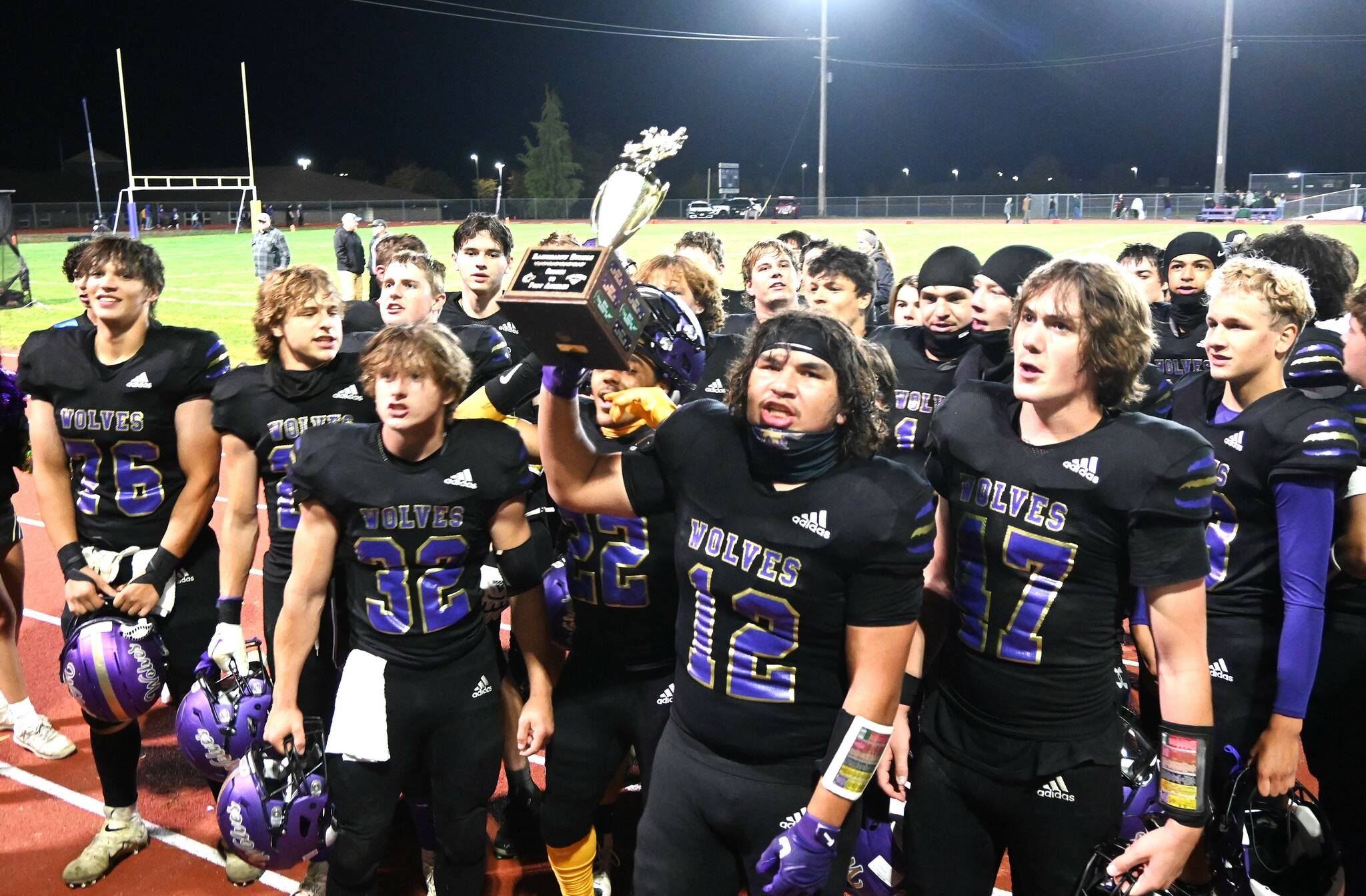 Sequim Gazette photos by Michael Dashiell
Liam Wiker (with trophy) and the Sequim Wolves celebrate winning the Rainshadow Rumble trophy in Sequim on Sept. 27, following a 27-7 Homecoming weekend win over rival Port Angeles.