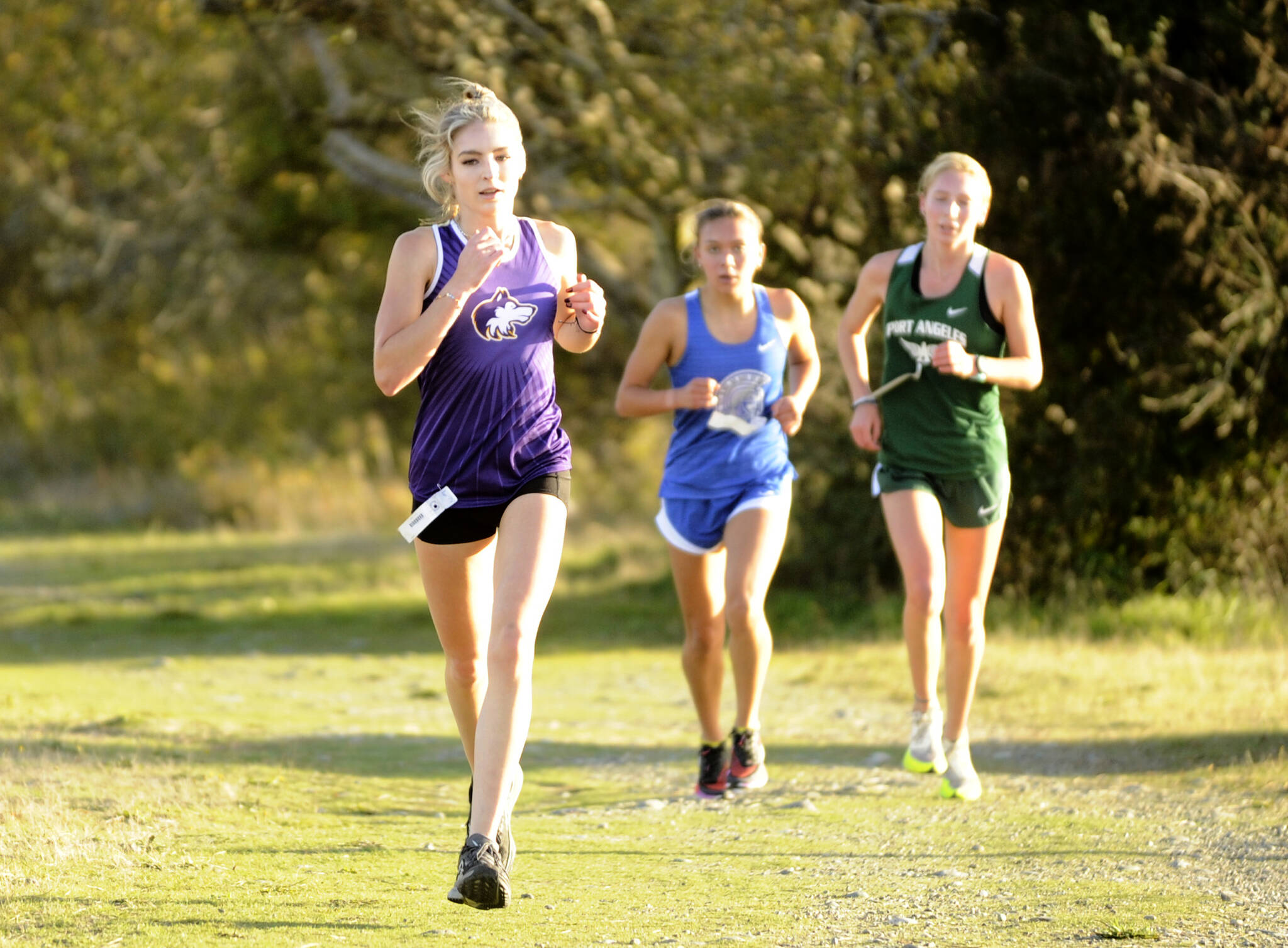 Sequim Gazette photo by Michael Dashiell 
Sequim’s Dawn Hulstedt runs ahead of Olympic’s Brynn Fulton and Port Angeles’ Leia Larson during the Olympic League cross country meet at Voice of America at the Dungeness Recreation Area on Oct. 2.