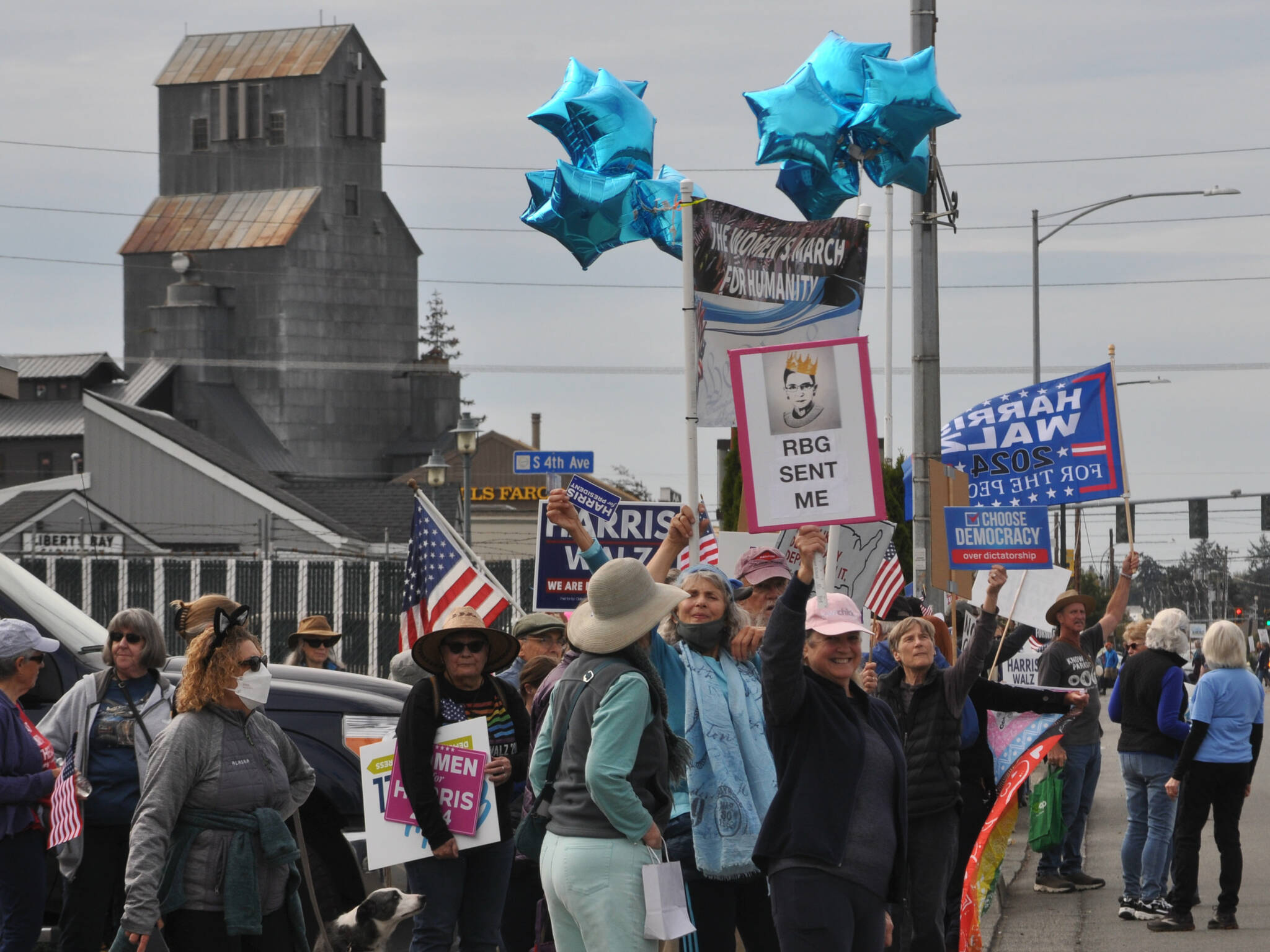 Sequim Gazette photos by Matthew Nash
Walkers during the Women’s March for Humanity continue down the south side of Washington Street after walking from Sequim Avenue to Fifth Avenue holding various campaign and political signs.