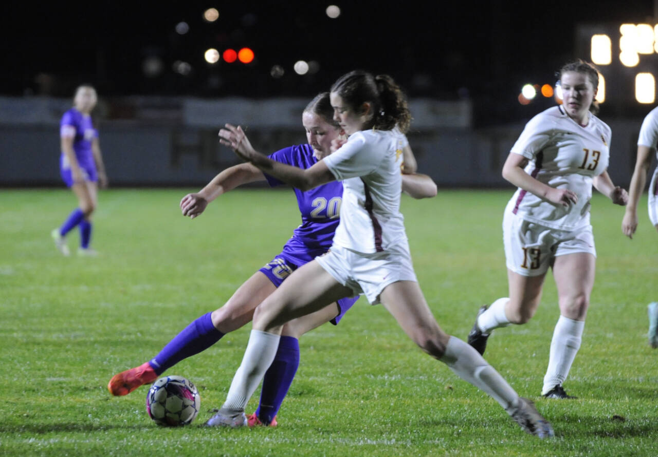 Sequim Gazette photo by Michael Dashiell
Sequim’s Sasha Yada, left, battles with Kingston’s Tayen Munger for the ball in an Olympic League match-up on Oct. 8. Yada had a first half score for the Wolves, but the Bucs prevailed 3-2 in overtime.