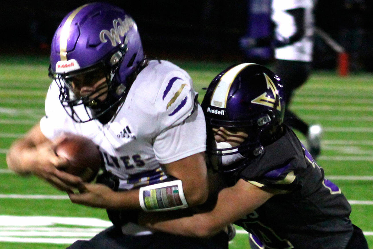 Photo by Elisha Meyer/Kitsap News Group Sequim’s Liam Wiker is tackled by North Kitsap’s Townsyn Walsh in the first half of the Wolves’ 30-7 Olympic League loss in Poulsbo on Oct. 10.