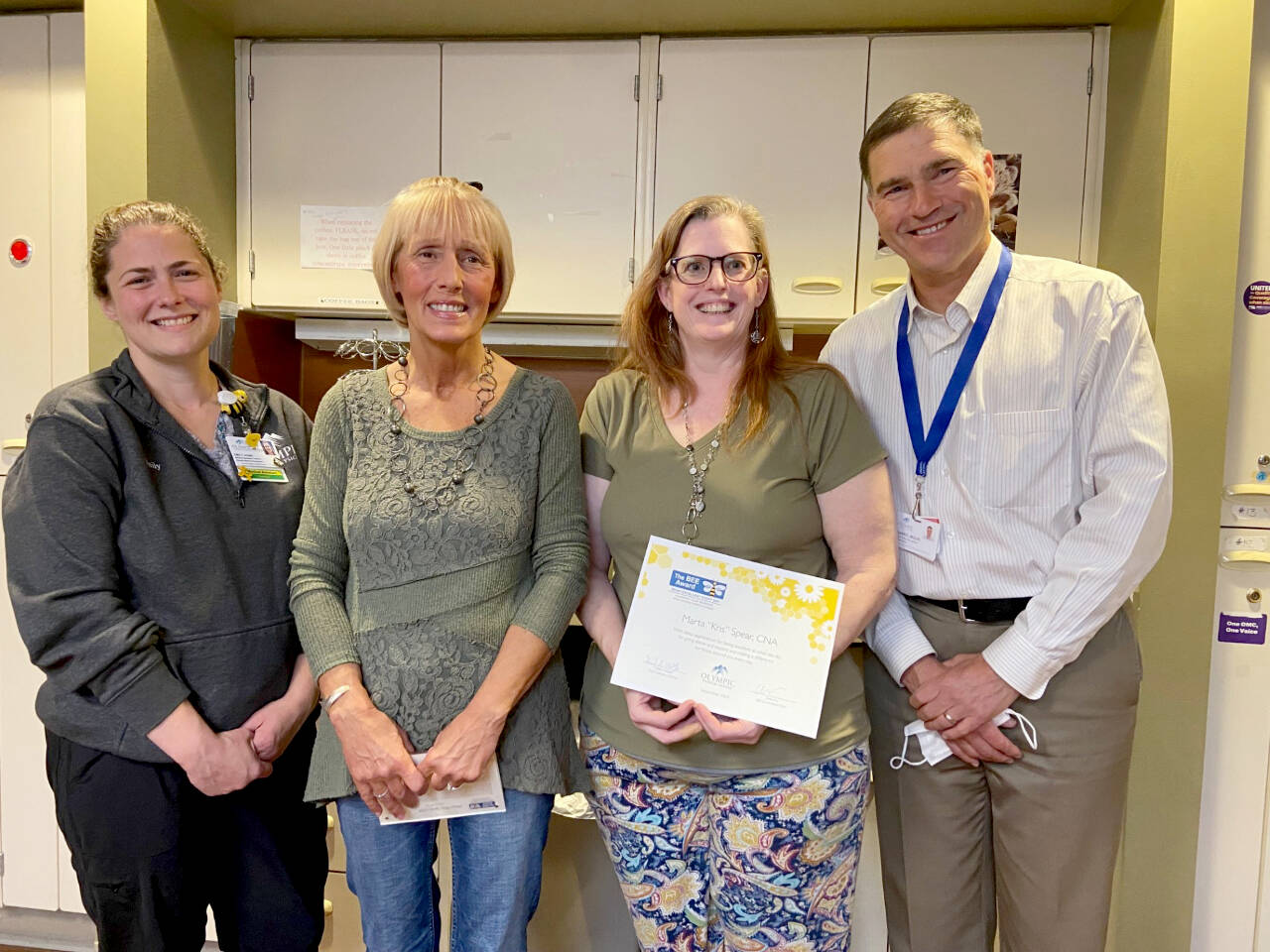 Photo courtesy of Olympic Medical Center 
Kris Spear, an Olympic Medical Center certified nursing assistant (second from left), receives an Olympic Medical Center BEE Award (Being Excellent Every Day) award. Pictured, from left, are BEE award chair Emily Fry, Spear, medical/surgical/pediatrics director Denise Harman and OMC CEO Darryl Wolfe.