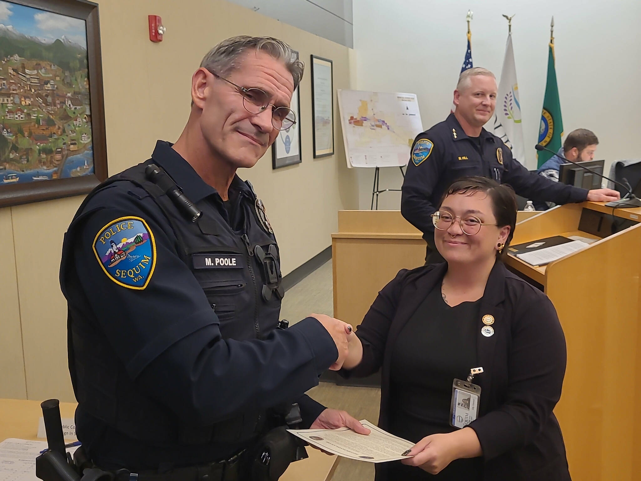 Photo courtesy John Southard/ Deputy Mayor Rachel Anderson thanks Sequim police officer Mark Poole with a proclamation of his Lifesaving Award on Oct. 14 for preventing a man from jumping from the River Road bypass in August.