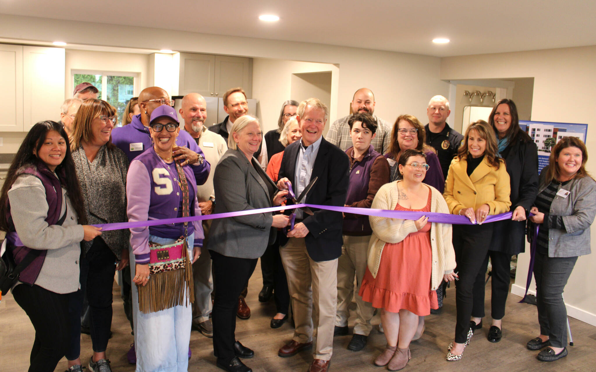 Photo courtesy Peninsula Behavioral Health
Wendy Sisk, CEO for Peninsula Behavioral Health, and Clallam County commissioner Randy Johnson ready to cut a ribbon with the Sequim-Dungeness Valley Chamber of Commerce on Oct. 16 for PBH’s first transitional house in Sequim. County funds helped pay for the refurbished home for five adults.