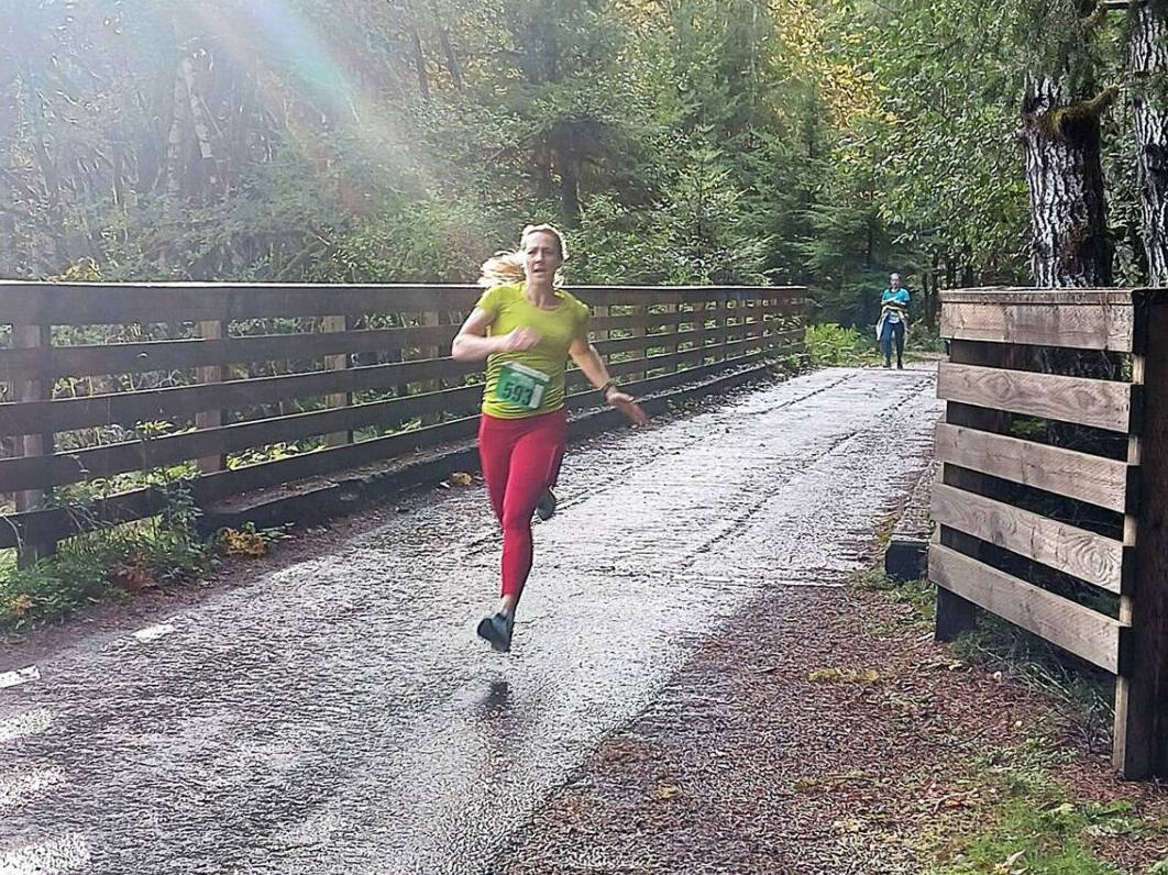 Photo by Pierre LaBossiere/ Olympic Peninsula News Group/ Sara Kuethe of Bainbridge Island won the women’s 10K at the inaugural Spruce Railroad Run at Lake Crescent on Saturday, Oct. 19.