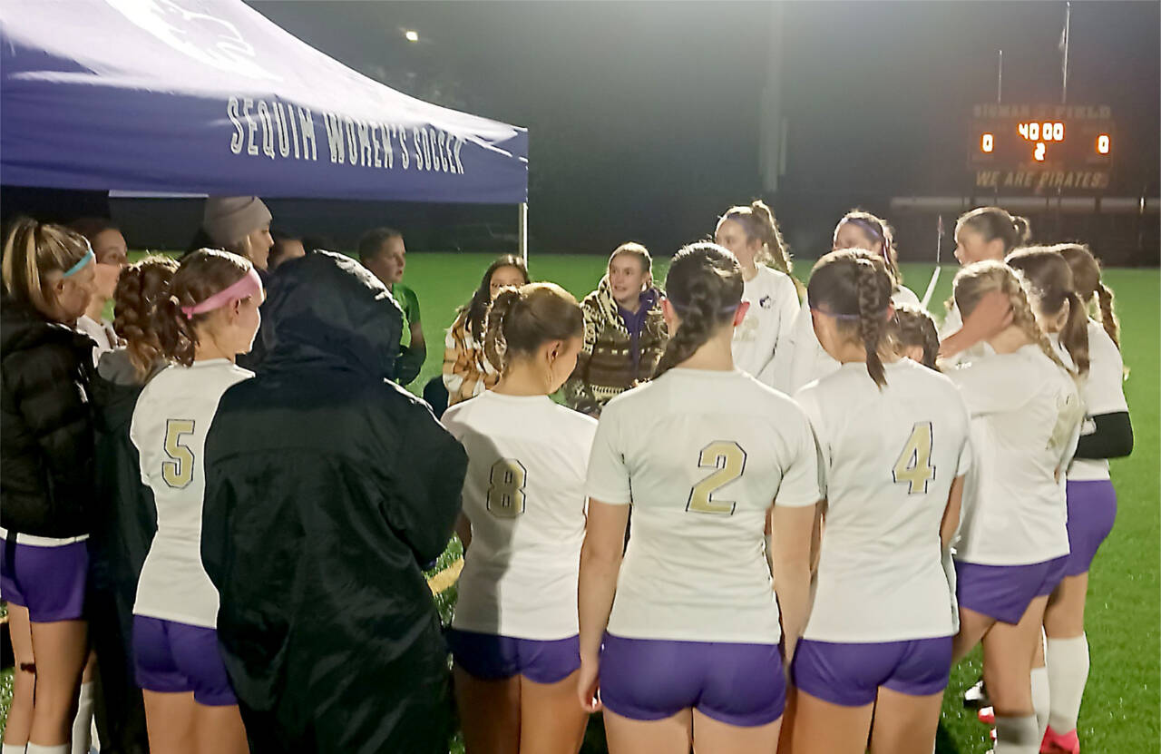 Sequim head coach Haley Hunsaker-Freeman talks with her team before Tuesday night's game at Port Angeles. (Pierre LaBossiere/Peninsula Daily News)