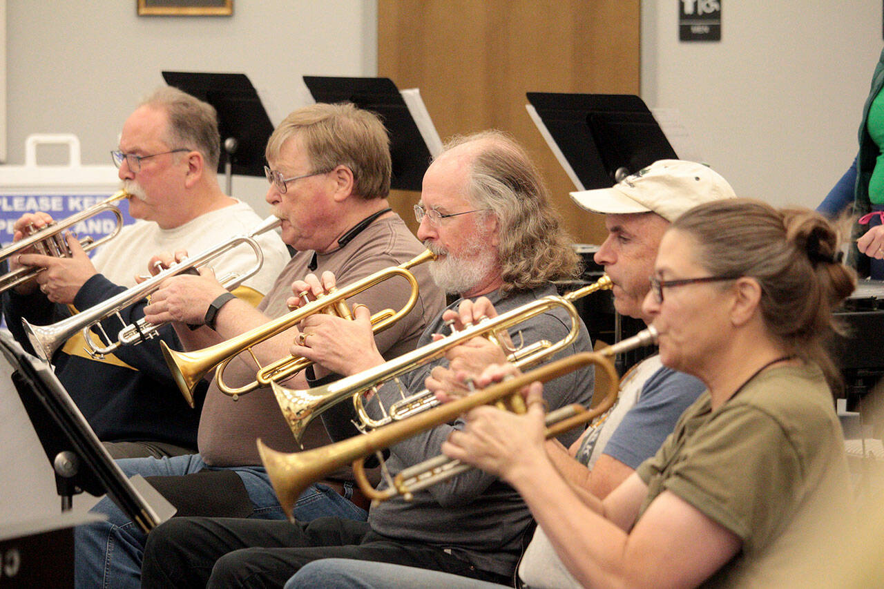 Photo by Mark Wick/Sequim City Band / From left, Jim Bradbury, Terry Fogerson, Michael Hornbaum, Doug Brundage and Nancy McPherson, the trumpet section of the Sequim City Band, play at a rehearsal.