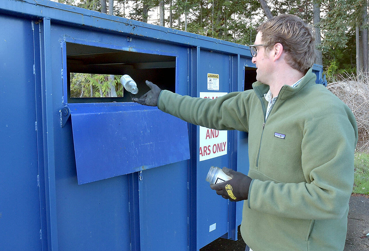 Photo by Keith Thorpe/Olympic Peninsula News Group
Beeler Van Orman of Port Angeles tosses a glass bottle into a recycling bin on Thursday at the Regional Transfer Station in Port Angeles.