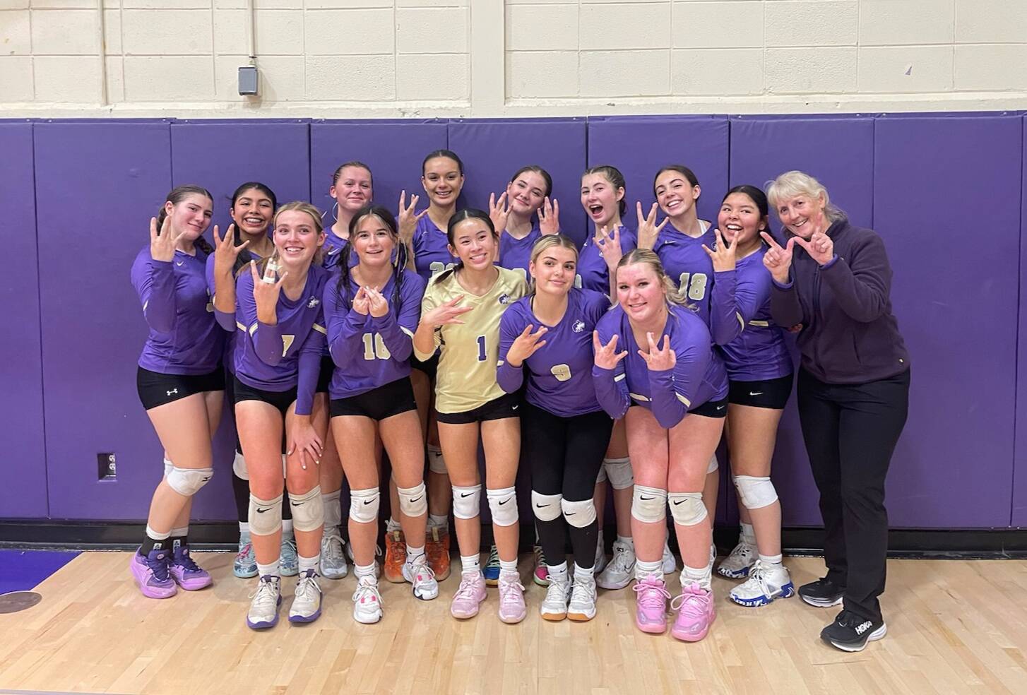 Photo courtesy of Sequim High volleyball
Sequim High School’s varsity volleyball squad celebrates a big win over rival North Kitsap in Poulsbo on Oct. 24.