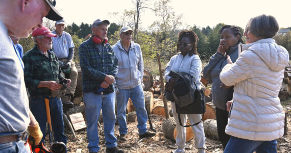 Sequim Gazette photos by Michael Dashiell
Agnes Kioko and Regina Mbaluku of Kenya and Bonita Piper, board president of Path From Poverty, right, meet with Sequim volunteers who cut and sell wood as a fundraiser.