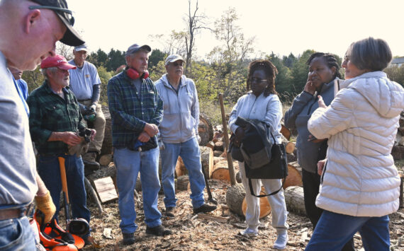 Sequim Gazette photos by Michael Dashiell
Agnes Kioko and Regina Mbaluku of Kenya and Bonita Piper, board president of Path From Poverty, right, meet with Sequim volunteers who cut and sell wood as a fundraiser.