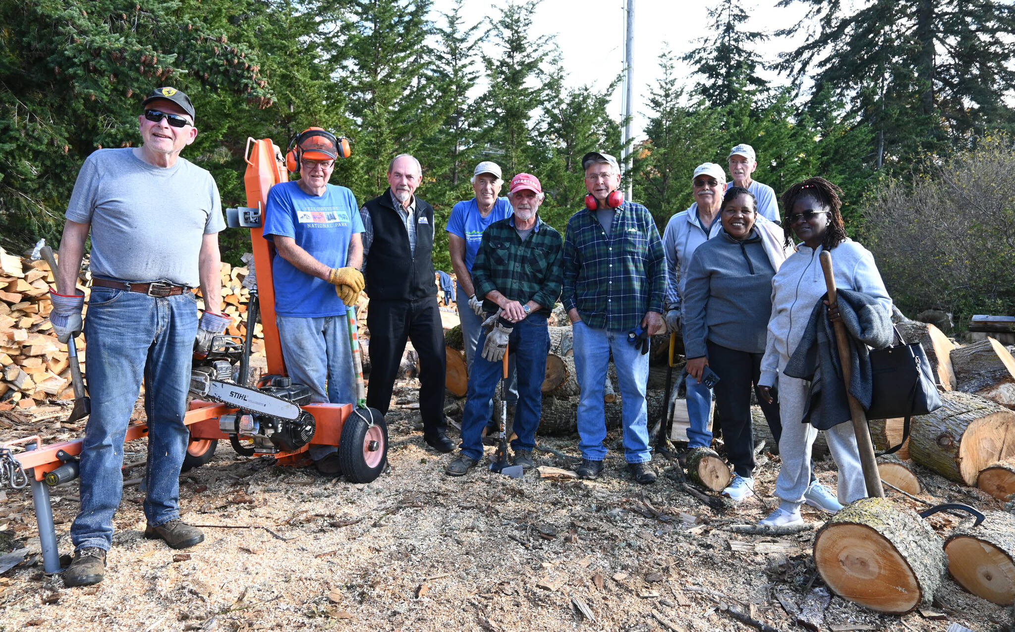 Sequim Gazette photo by Michael Dashiell / Agnes Kioko and Regina Mbaluku of Kenya, right, meet with Sequim volunteers who cut and sell wood as a fundraiser.