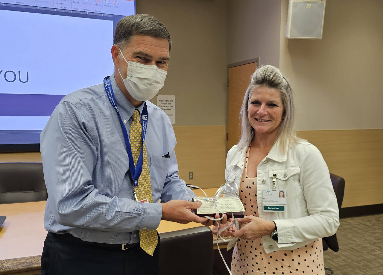 Photo courtesy of Olympic Medical Center / Nikki Brown,
Olympic Medical Physicians’ call center supervisor, receives an Olympic Medical Center Leadership Award from OMC CEO Darryl Wolfe.