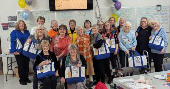 Photos by Christine Brehan
Olympic Peninsula Doll Club members pose with their new OPDC 50th birthday tote bags.