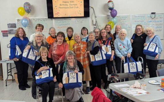 Photos by Christine Brehan
Olympic Peninsula Doll Club members pose with their new OPDC 50th birthday tote bags.