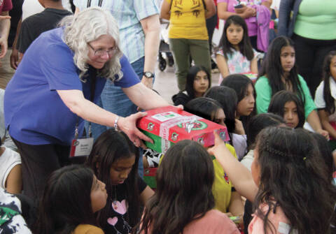 Photo courtesy of Susan Heddning
Sequim residents and Operation Christmas Child volunteer, Susan Hedding, participated in the distribution of shoebox gifts packed here as she handed them out to children in Quito, Ecuador.