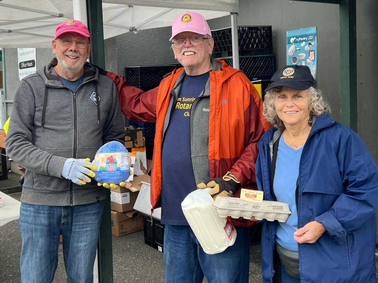 Photo courtesy Sequim
 Sunshine Rotary
David Barker, and Randy and Deb Brooks volunteer for the Sequim Sunshine Rotary at the Sequim Food Bank.