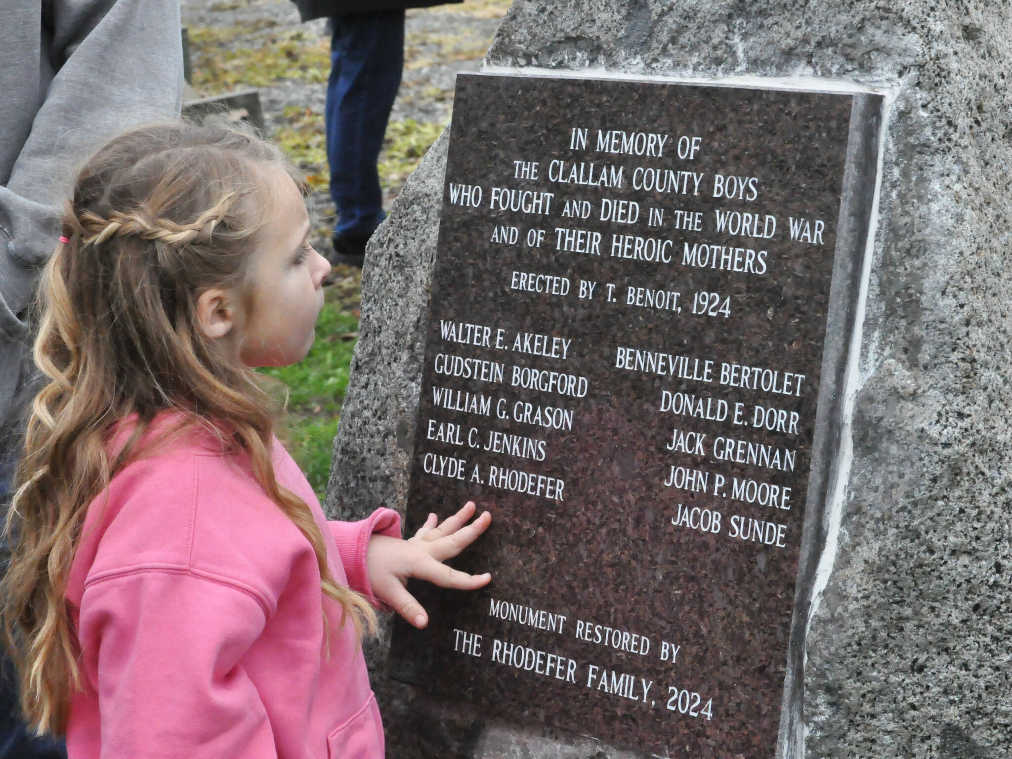 Sequim Gazette photos by Matthew Nash
Clara (Rhodefer) Muma, 5, looks at a memorial honoring her great-great-great uncle Clyde Rhodefer of Sequim in front of Carlsborg Family Church on Nov. 9. The plaque was replaced and added the names of the men from Clallam County who died in World War I.