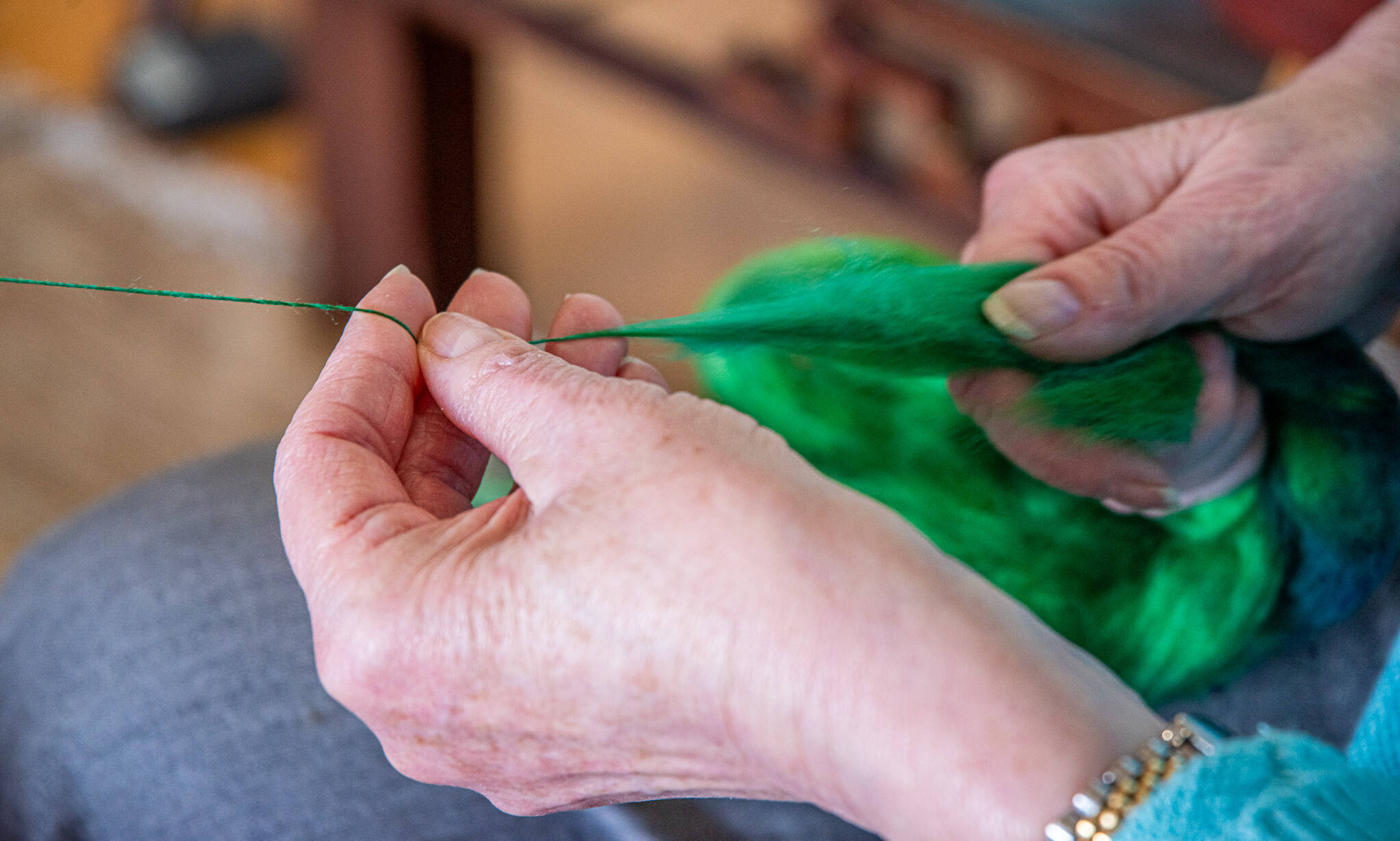 Sequim Gazette photo by Emily Matthiessen
 Lynn Baritelle demonstrates spinning fiber into thread at her home in Sequim. Baritelle is a well respected fiber artist and a member of the North Olympic Shuttle and Spindle Guild with a master’s degree in textiles.