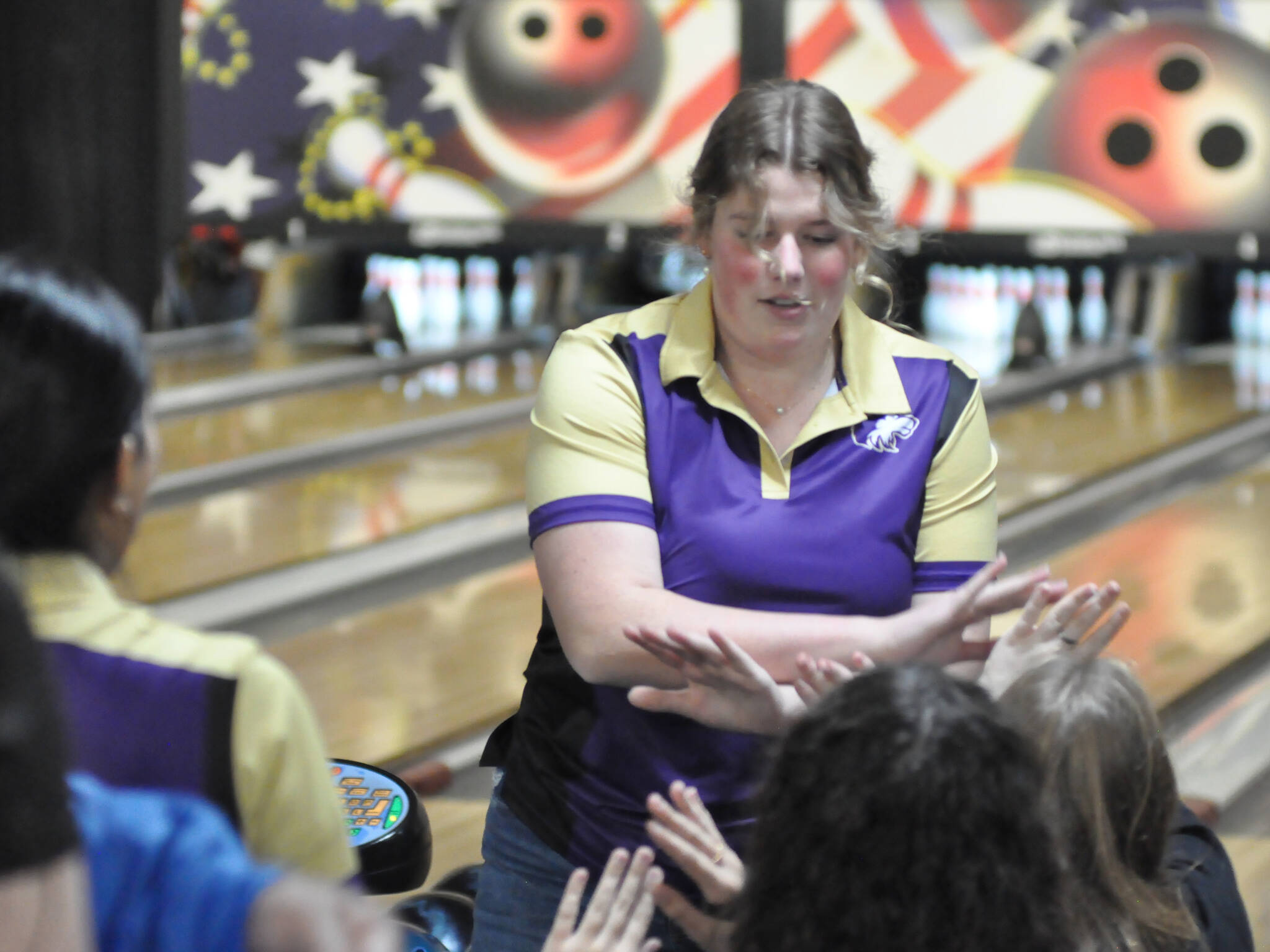 Sequim Gazette photo by Matthew Nash 
Skylar Krzyworz high-fives teammates after bowling a strike in her last frame on Nov. 21 in Port Angeles.