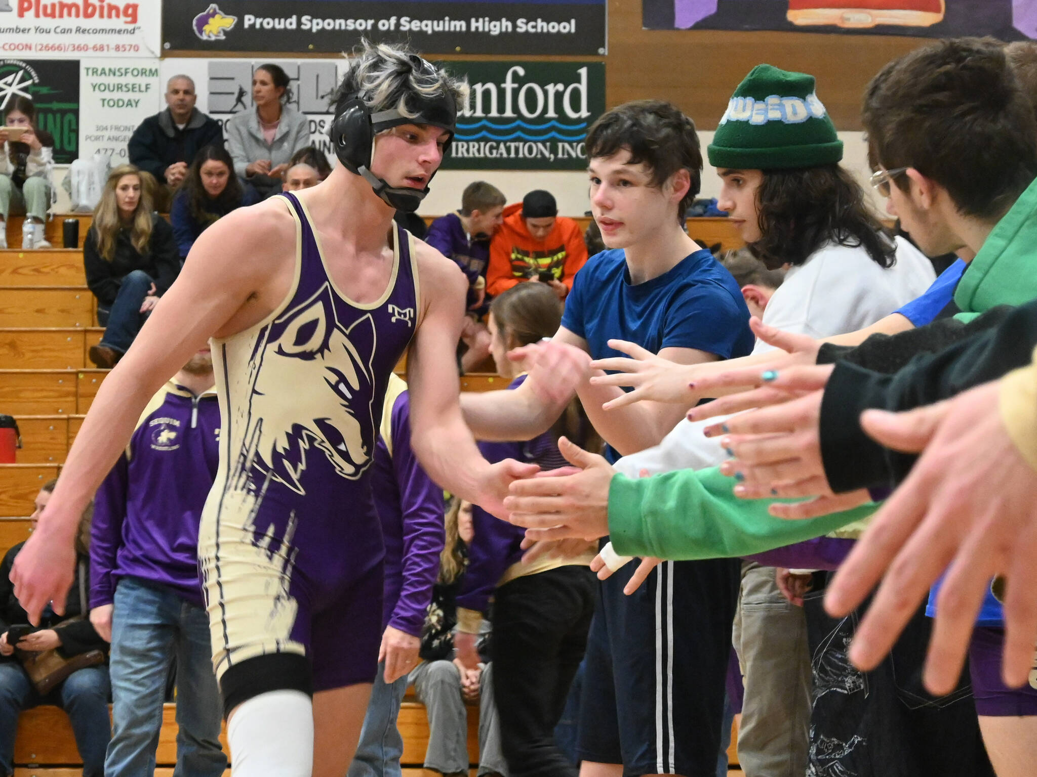 Sequim Gazette file photo by Michael Dashiell 
Sequim’s Jayms Vilona gets congratulated by teammates after a win over his Bremerton foe on Jan. 10. He’s one of the upperclassmen wrestlers anticipated to a make a continued leap forward, said new head coach Tyler Izatt.